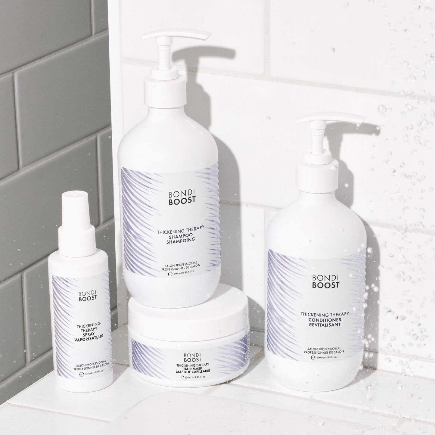 Bondi Boost hair care products on a bathroom shelf with tiled wall background