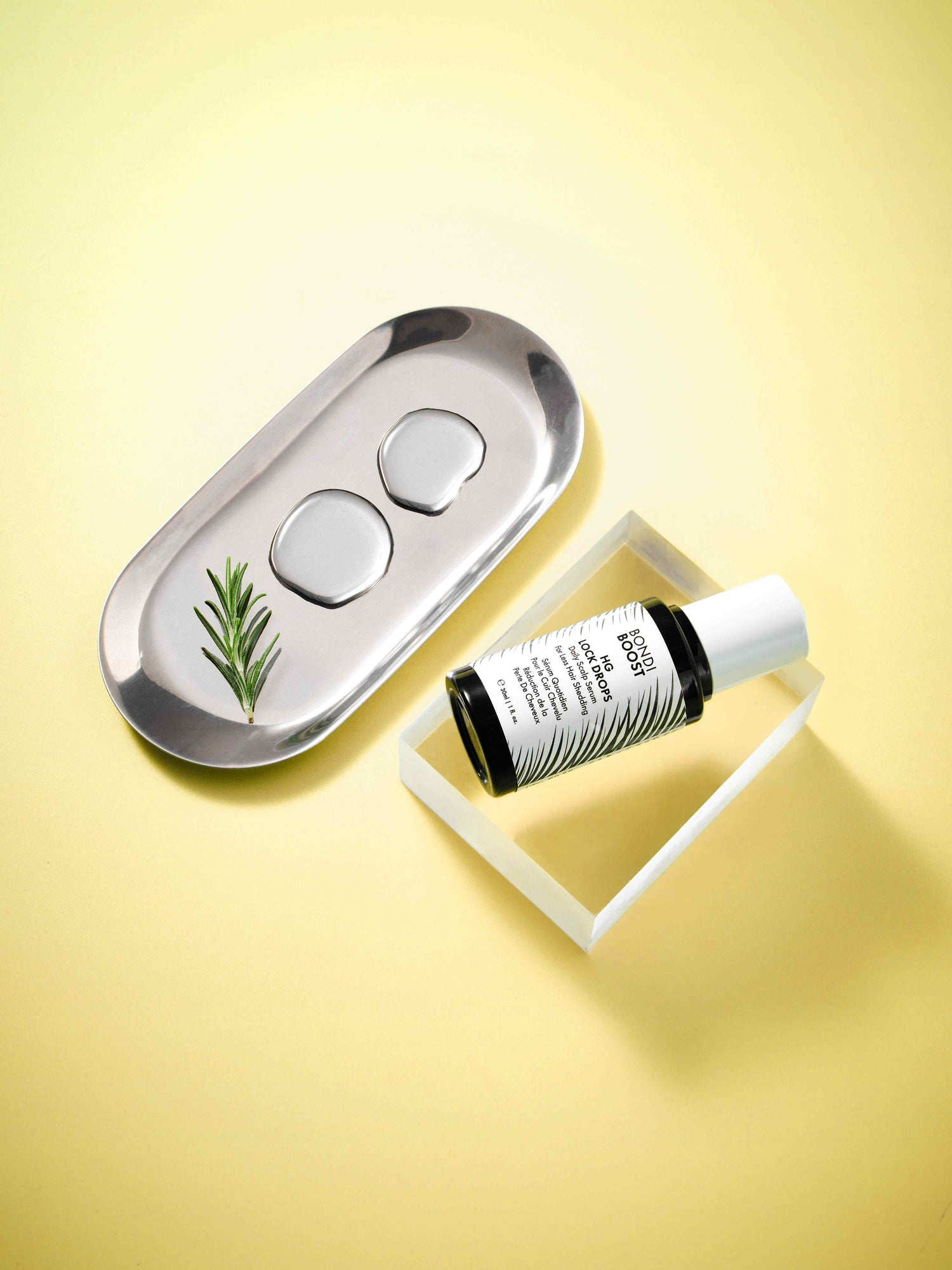 Roll-on bottle with a white cap and black label on a yellow background