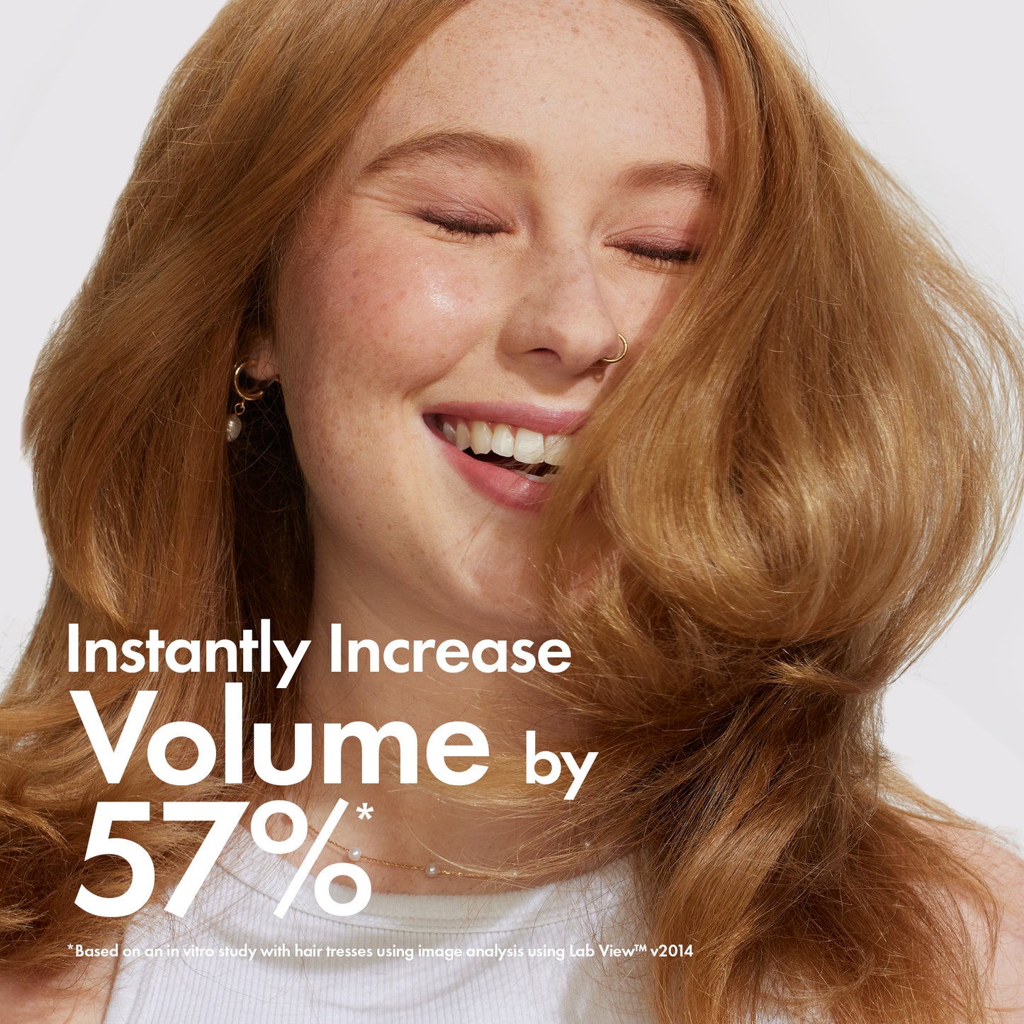 Woman with voluminous hair smiling, with text about volume increase.