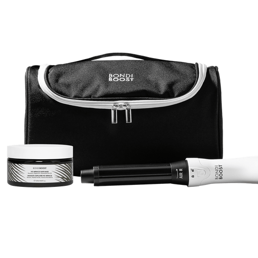 Bondi Boost hair care product set with black pouch, jar, and white device on a black background