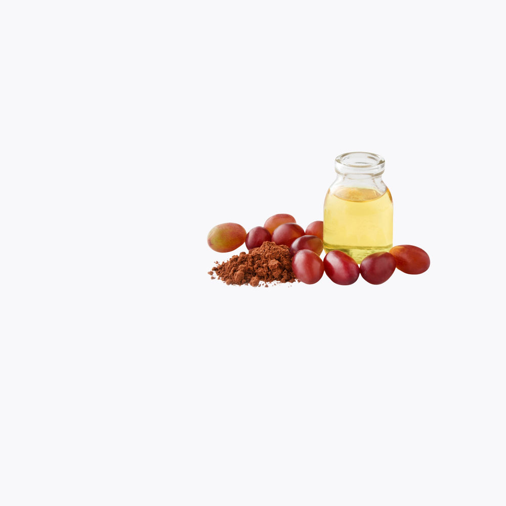Bottle of oil with grapes and cocoa powder on a white background