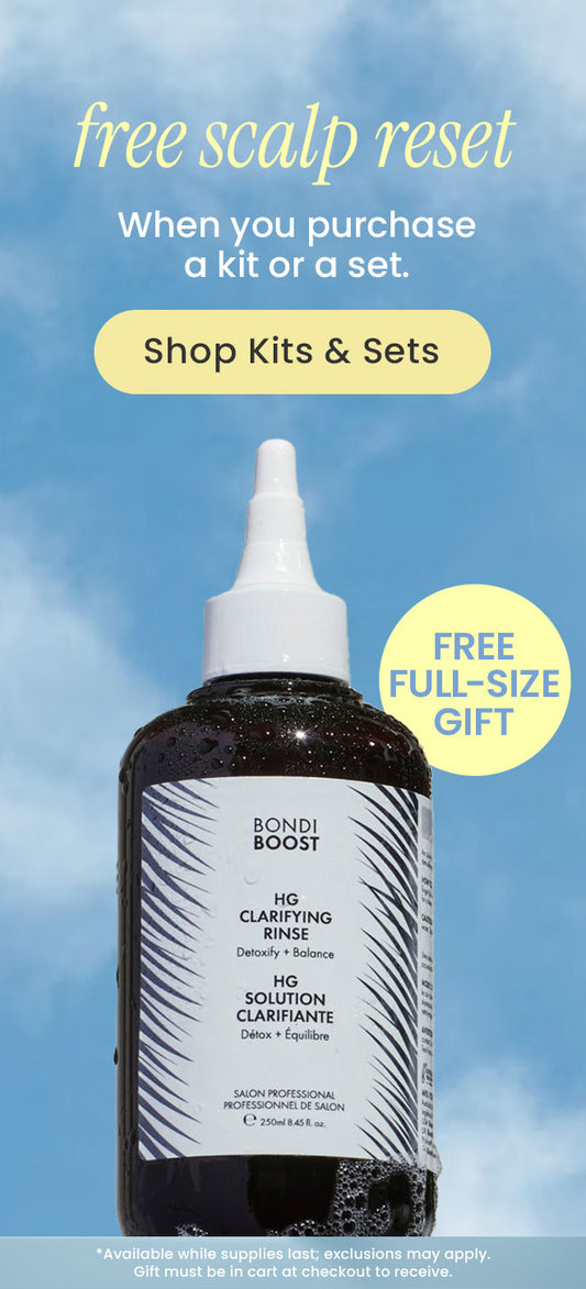 Bottle of Bondi Boost hair clarifying solution with promotional text on a blue sky background