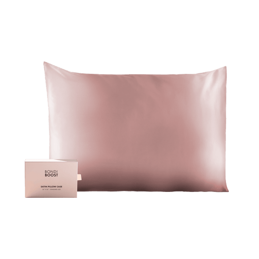 Pink satin pillowcase with a small box labeled 'BONDI BOOST' on a black background