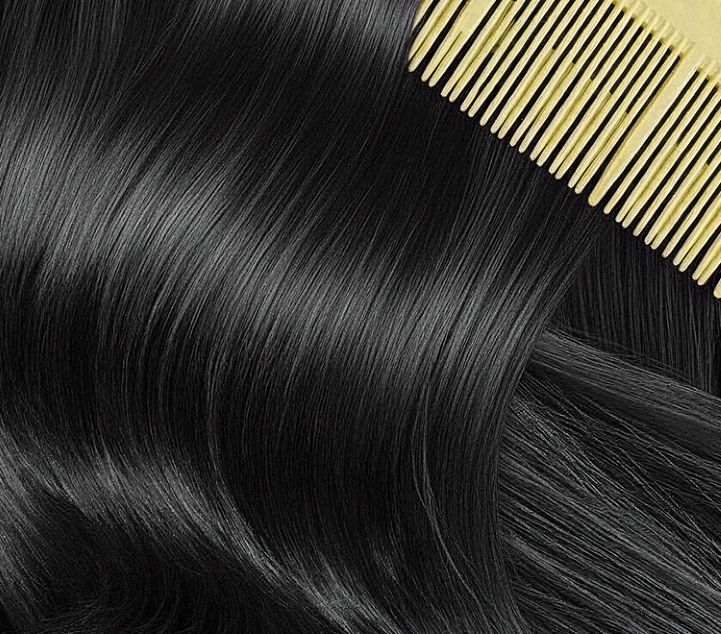 Black hair with a yellow comb on a black background