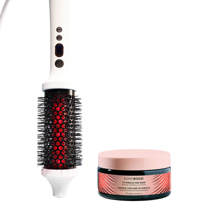 Hairbrush with red bristle head and BondiBoost hair mask on a white background